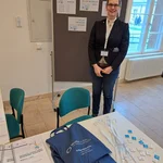 C. Heinrich at registration desk