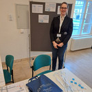 C. Heinrich at registration desk