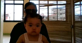 Baby sitting on its mother's lap