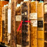 This image shows a row of books in Hebrew in a shelf at the University Library.