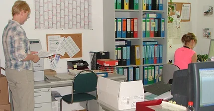 disorderly office and two working persons