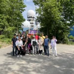 group of researchers in front of Teufelsberg buildings