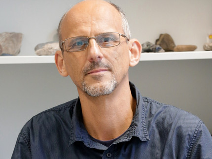 Professor van der Beek in his office in front of geological samples