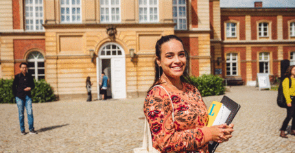 Student girl with a dictionary in her arm for German language programs