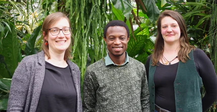 the coordinators standing in front of tropical plants