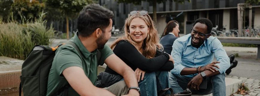 three students talking and laughing
