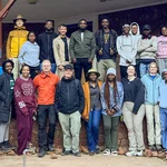 Rund 20 Menschen posieren für ein Gruppenfoto