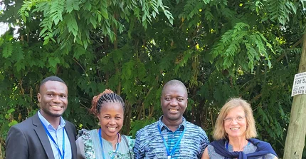 the scientists standing in front of trees