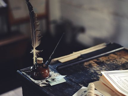 Quill and ink on a table