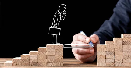 A coach draws a bridge to support a stick figure standing in front of a gap