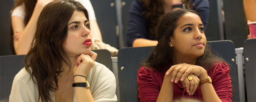 Two young women in a lecture hall