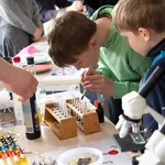 Zwei Jungen an einem Experimentierstand.