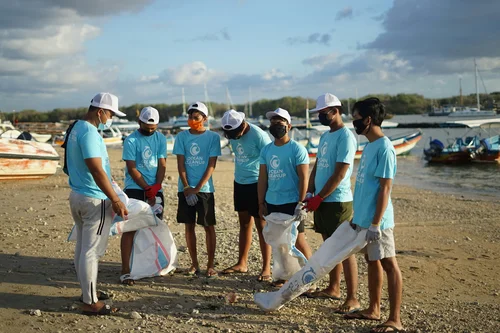 Gruppe von freiwilligen helfern am Strand.