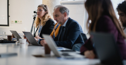 Persons sitting in a meeting