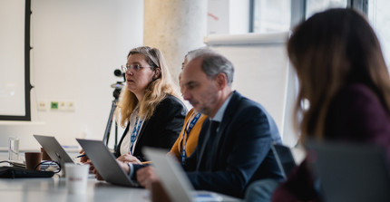 Persons sitting in a meeting