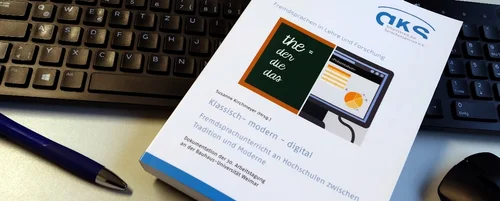 Fachzeitschrift vor Tastatur und Maus