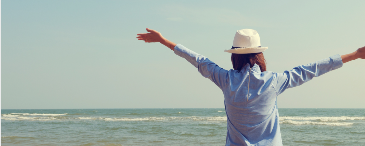 Frohe Frau am Strand und Horizont - 