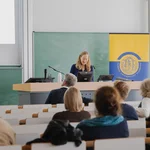 Ein Referentin vor mehreren Zuhörenden