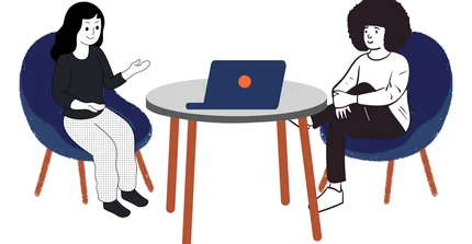 Beratungssituation mit zwei Personen am Tisch und einem Laptop.