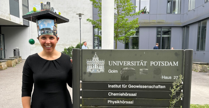 Lisa wearing her doctoral hat